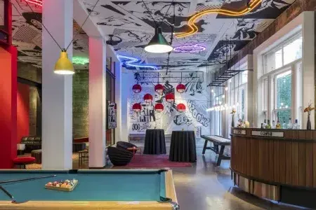 Image of interior of Hotel Zeppelin, pool table and neon lights in view.